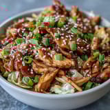 Sizzling Egg Roll Bowls with Chicken and Cabbage feature tender chicken and crisp veggies tossed in a savory soy-sesame glaze for an easy, low-carb dinner.