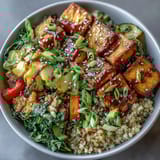 A colorful quinoa vegetable teriyaki bowl with crisp stir-fried veggies and savory sauce, perfect for a wholesome vegan meal.  