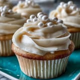 Delicate vanilla cupcakes for Cancer birthdays, adorned with shimmering pearl fondant details.