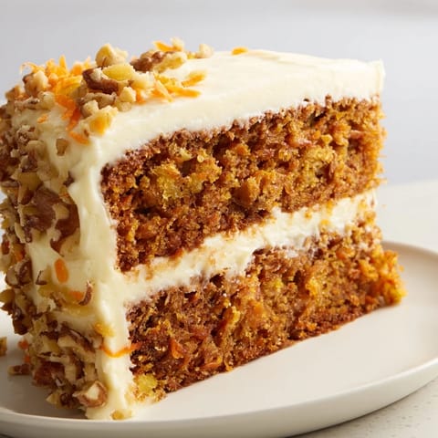 A layered carrot cake, beautifully frosted with cream cheese, perfect for a special celebration.