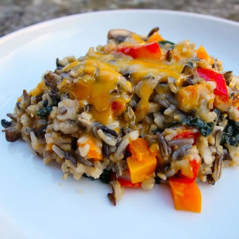 Steaming wild rice casserole with mushrooms and vegetables, a perfect vegetarian side or dinner.