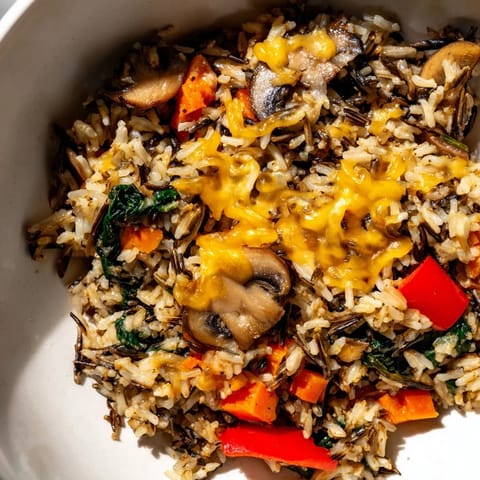 Golden-brown Gruyère tops this hearty wild rice casserole, bubbling hot from the oven with inviting smells.
