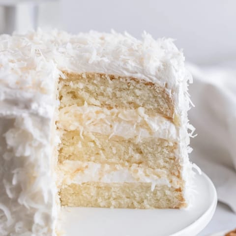 Fluffy layers of Coconut Cake, frosted high with billowy meringue and toasted coconut.