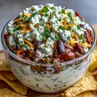 Easy Taco Dip Cups filled with creamy layers, fresh veggies, and cheese, perfect for festive gatherings.